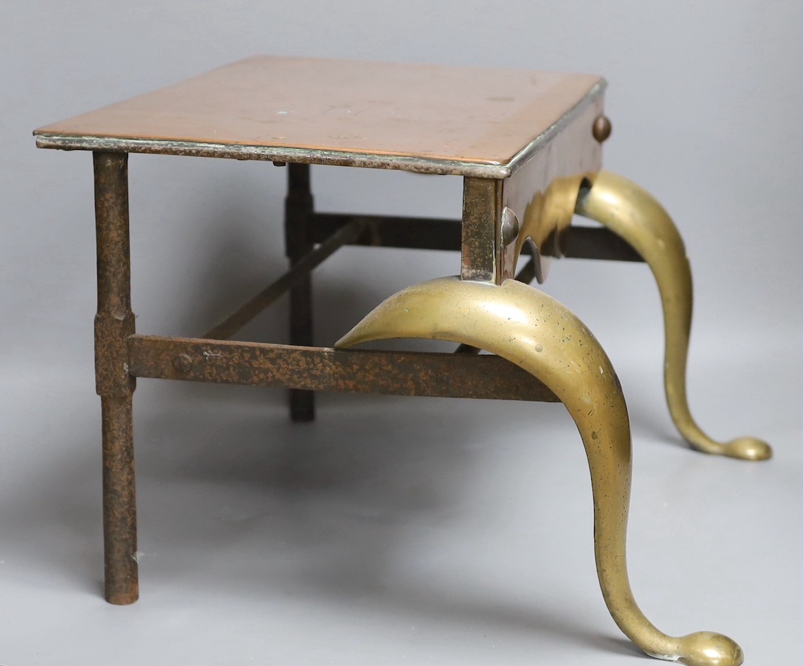 A Georgian brass and copper footman, 28 cms high x 42 cms wide